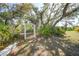 Enchanting yard featuring an arbor, mature trees and a stone path at 16180 Forest Glen Ct, Punta Gorda, FL 33982