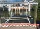 Modern boat lift on a canal with secure supports, designed for easy boat storage at 2061 S Pine St, Englewood, FL 34224