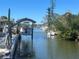 A clear canal view with boats docked and boat lift, highlighting the waterfront property at 2061 S Pine St, Englewood, FL 34224
