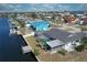 A high angle view showing a home with a screened pool, canal access and private boat dock at 234 Tait Se Ter, Port Charlotte, FL 33952