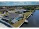 An aerial view of a home with a screened in pool, water access and private dock at 234 Tait Se Ter, Port Charlotte, FL 33952