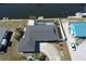 Waterfront property with screened-in pool, lush landscaping, and boat dock on canal, offering serene outdoor living at 234 Tait Se Ter, Port Charlotte, FL 33952