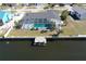 An aerial shot of a single Gathering home with a screened in pool and private dock on the canal at 234 Tait Se Ter, Port Charlotte, FL 33952