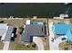 Stunning aerial view of waterfront home featuring a private pool, boat dock, and lush landscaping at 234 Tait Se Ter, Port Charlotte, FL 33952