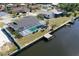An aerial of a property featuring a screened pool, waterfront access and private boat dock at 234 Tait Se Ter, Port Charlotte, FL 33952
