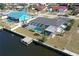 Aerial view of a single Gathering home featuring a screened in pool and private dock on a canal at 234 Tait Se Ter, Port Charlotte, FL 33952