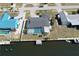 Aerial view of a charming home featuring a private pool, canal access, and a boat dock at 234 Tait Se Ter, Port Charlotte, FL 33952