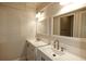 Bright bathroom featuring double sinks and vanities with quartz countertops at 234 Tait Se Ter, Port Charlotte, FL 33952