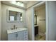 Updated bathroom featuring a stylish vanity, modern fixtures, and a doorway leading to a well-appointed toilet room at 234 Tait Se Ter, Port Charlotte, FL 33952