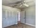 Cozy bedroom with a ceiling fan, tiled floors and a closet with folding doors at 234 Tait Se Ter, Port Charlotte, FL 33952
