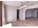 Bright dining room with an elegant chandelier and access to the kitchen and living area at 234 Tait Se Ter, Port Charlotte, FL 33952