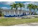 Inviting single-story home with vibrant blue trim and well-manicured lawn adorned with lovely palm trees at 234 Tait Se Ter, Port Charlotte, FL 33952