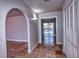 Hallway with tile flooring, neutral walls, and arched doorway with pool view, creating a bright and inviting space at 234 Tait Se Ter, Port Charlotte, FL 33952