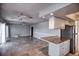 Open living space featuring tile floors, white trim, and a granite countertop overlooking the kitchen at 234 Tait Se Ter, Port Charlotte, FL 33952