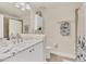 Well-lit bathroom with white cabinets, neutral tile, and decorative coastal accents at 240 W End Dr # 312, Punta Gorda, FL 33950