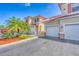 Well-maintained townhome exterior featuring a driveway, landscaping, stucco finish, and a terracotta roof at 240 W End Dr # 312, Punta Gorda, FL 33950