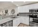 Updated kitchen features stainless steel appliances, white cabinets, and granite countertops at 240 W End Dr # 312, Punta Gorda, FL 33950