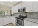This kitchen features stainless steel appliances, white cabinets and granite countertops at 240 W End Dr # 312, Punta Gorda, FL 33950