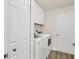 Clean laundry area with modern washer and dryer, storage cabinets, and white doors at 240 W End Dr # 312, Punta Gorda, FL 33950
