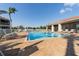 Inviting community pool surrounded by lounge chairs and beautiful landscaping at 240 W End Dr # 312, Punta Gorda, FL 33950