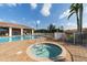 Community pool area showcasing a luxurious spa, lounge chairs, and tropical landscaping at 240 W End Dr # 312, Punta Gorda, FL 33950