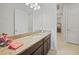 Bathroom featuring a long granite countertop and dark wood cabinets at 24407 Riverfront Dr, Punta Gorda, FL 33980