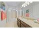 Bright bathroom featuring a granite countertop, shower with tub, and neutral tile flooring at 24407 Riverfront Dr, Punta Gorda, FL 33980