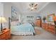 Cozy primary bedroom with neutral walls, ceiling fan, carpet flooring, and a window with wood-slat blinds at 24407 Riverfront Dr, Punta Gorda, FL 33980