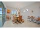 Cozy dining area with a round table, comfortable seating, and natural light from surrounding windows at 24407 Riverfront Dr, Punta Gorda, FL 33980
