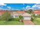 Beautiful well-maintained home with lush green landscaping and charming curb appeal at 24407 Riverfront Dr, Punta Gorda, FL 33980