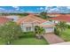 Well-maintained home with red brick driveway, mature palm trees, and lush landscaping at 24407 Riverfront Dr, Punta Gorda, FL 33980