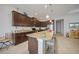 Well-equipped kitchen featuring a spacious island with granite countertops, dark cabinetry, and modern appliances at 24407 Riverfront Dr, Punta Gorda, FL 33980
