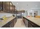 Gourmet kitchen featuring stainless steel appliances, granite countertops, dark cabinets, and tile flooring at 24407 Riverfront Dr, Punta Gorda, FL 33980