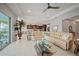 Open living area with tile flooring, ceiling fan, combined with an eat-in kitchen and access to screened lanai at 24407 Riverfront Dr, Punta Gorda, FL 33980