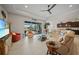 Bright living room features an open floor plan, tile floors, and a large sliding glass door to the lanai at 24407 Riverfront Dr, Punta Gorda, FL 33980