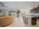 Open-concept living space seamlessly connects the kitchen, dining area, and living room, with a view of the pool area at 24407 Riverfront Dr, Punta Gorda, FL 33980