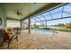 Screened-in pool and covered lanai with beautiful lake view, perfect for outdoor entertaining and relaxation at 24407 Riverfront Dr, Punta Gorda, FL 33980
