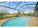 Screened-in pool with serene lake views and inviting pool-side patio at 24407 Riverfront Dr, Punta Gorda, FL 33980