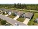 Aerial view of homes featuring manicured lawns and well-maintained landscaping, conveying curb appeal and community pride at 25292 E Lenox Cir, Punta Gorda, FL 33950