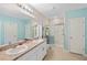 Bathroom with double vanity, framed mirrors, and walk-in shower at 25292 E Lenox Cir, Punta Gorda, FL 33950
