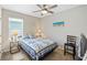 Comfortable bedroom with a quilt, ceiling fan, and natural light at 25292 E Lenox Cir, Punta Gorda, FL 33950