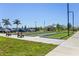 Bocce ball courts with seating, palm trees, and car parking in the background at 25292 E Lenox Cir, Punta Gorda, FL 33950