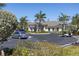 Community clubhouse with ample parking and lush landscaping, ideal for gatherings and events at 25292 E Lenox Cir, Punta Gorda, FL 33950