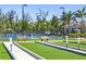 Community amenity featuring bocce ball courts and pickleball courts with palm trees at 25292 E Lenox Cir, Punta Gorda, FL 33950