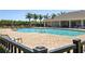 Community pool with lounge chairs and palm trees, perfect for relaxation at 25292 E Lenox Cir, Punta Gorda, FL 33950