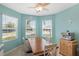 Bright dining area with aqua colored walls, ceiling fan and views from three windows at 25292 E Lenox Cir, Punta Gorda, FL 33950