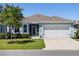 Charming single-story home with a two-car garage and well-manicured lawn and garden at 25292 E Lenox Cir, Punta Gorda, FL 33950