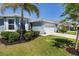 Beautiful home with a lush green lawn, palm tree, and well-maintained landscaping at 25292 E Lenox Cir, Punta Gorda, FL 33950