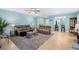 Bright and airy living room with comfortable sofas and an open floor plan to the kitchen at 25292 E Lenox Cir, Punta Gorda, FL 33950