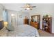 Cozy main bedroom features a ceiling fan and a rustic dresser, providing ample storage space at 25292 E Lenox Cir, Punta Gorda, FL 33950
